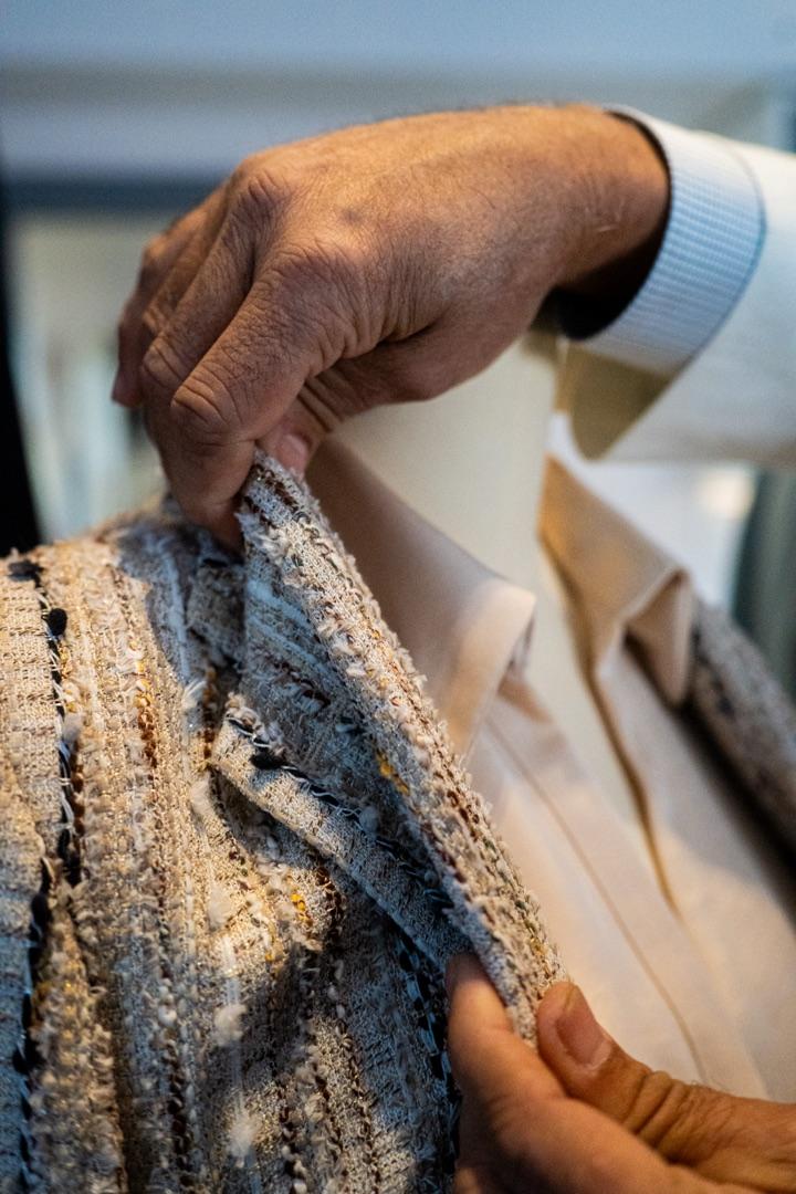 Hand-fitting a tweed jacket on the form